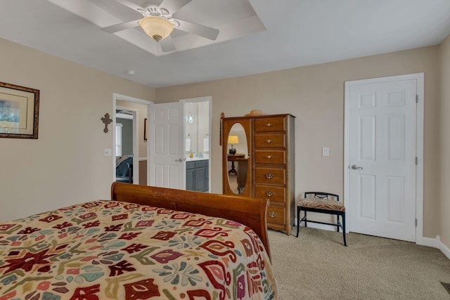 bedroom with ceiling fan, connected bathroom, and light carpet