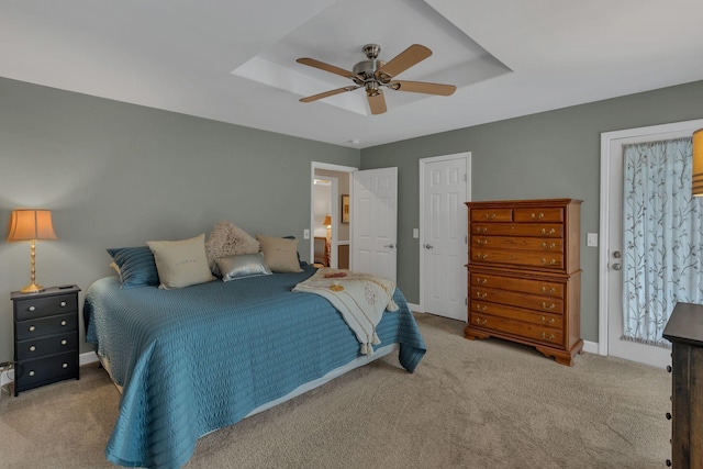 bedroom with a tray ceiling, carpet floors, and ceiling fan