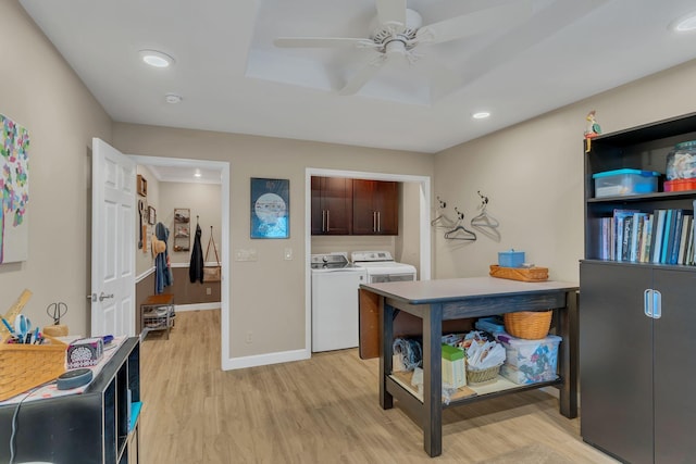 laundry room featuring ceiling fan, cabinets, separate washer and dryer, and light wood-type flooring