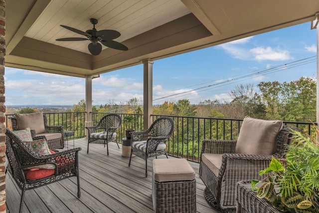 wooden deck with ceiling fan and outdoor lounge area