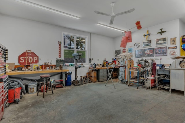 garage featuring ceiling fan and a workshop area