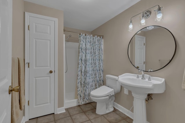 bathroom featuring tile patterned flooring, a shower with curtain, and toilet