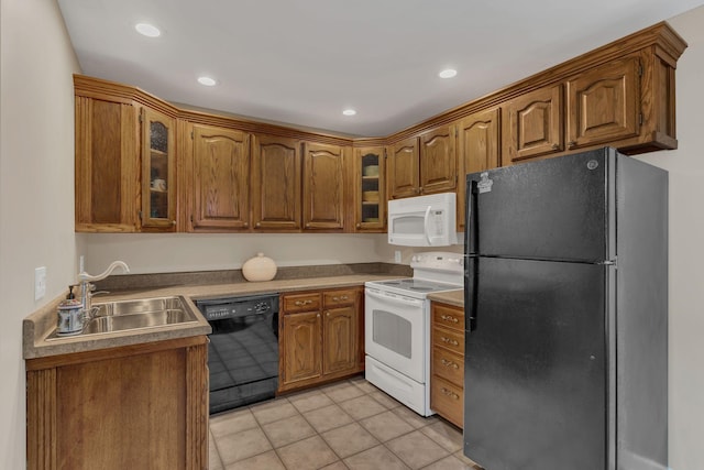 kitchen with sink, light tile patterned floors, and black appliances