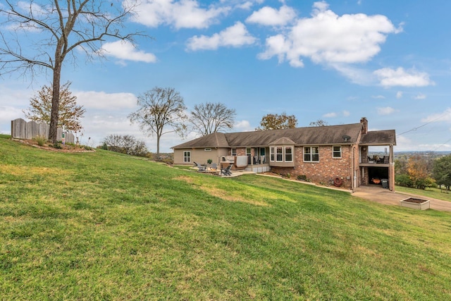 back of property with a yard and a patio area