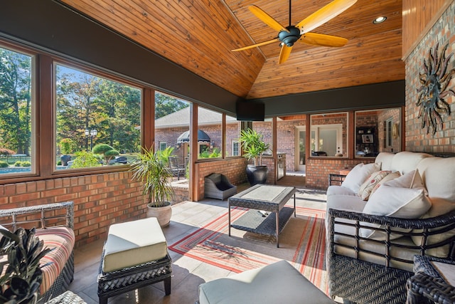 sunroom with lofted ceiling, ceiling fan, and wooden ceiling