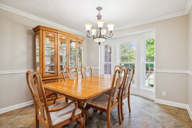 dining area with a chandelier, a healthy amount of sunlight, a textured ceiling, and ornamental molding