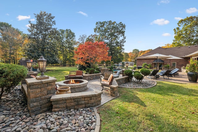 view of yard with a patio and an outdoor fire pit