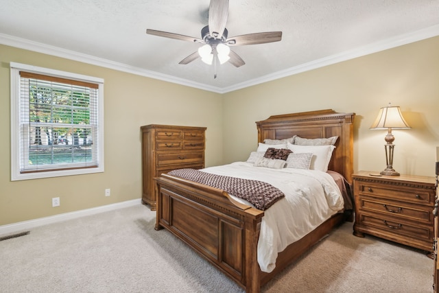 bedroom with ceiling fan, a textured ceiling, crown molding, and light colored carpet