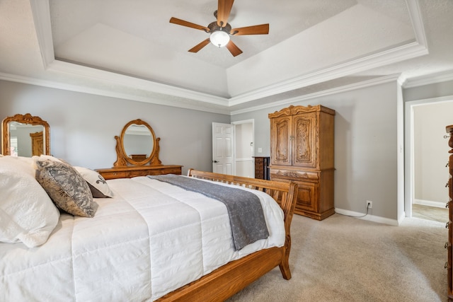 bedroom with a tray ceiling, light carpet, ceiling fan, and crown molding