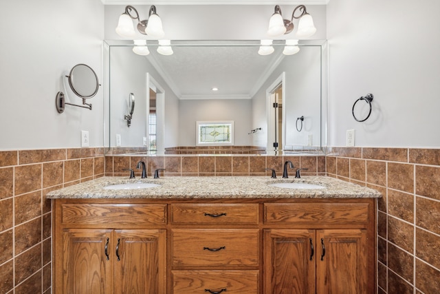 bathroom with tile walls, vanity, and crown molding