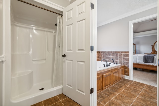 bathroom with tile patterned floors, shower with separate bathtub, a textured ceiling, and ornamental molding