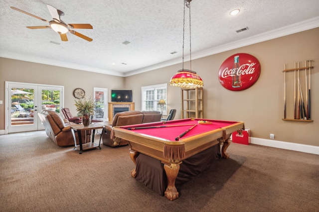 recreation room with french doors, a textured ceiling, carpet, ceiling fan, and crown molding