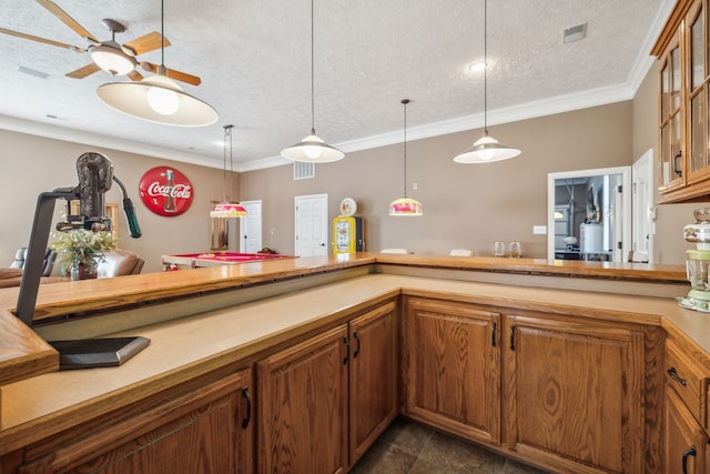 kitchen featuring ceiling fan, a textured ceiling, pendant lighting, and crown molding