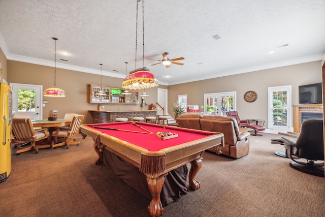 game room featuring ornamental molding, a textured ceiling, ceiling fan, and carpet floors