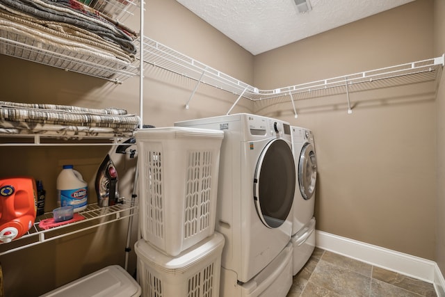 washroom featuring a textured ceiling and separate washer and dryer