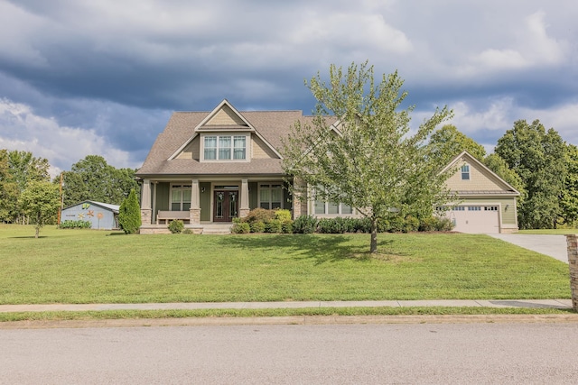 craftsman house featuring covered porch, a front yard, and a garage