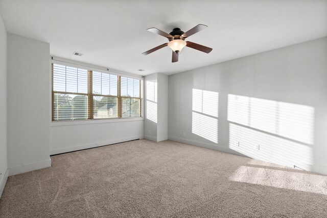 empty room with light carpet and ceiling fan