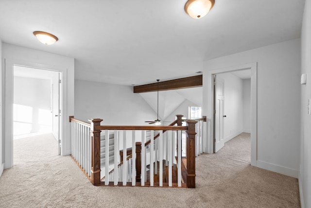 hall with carpet floors and lofted ceiling with beams