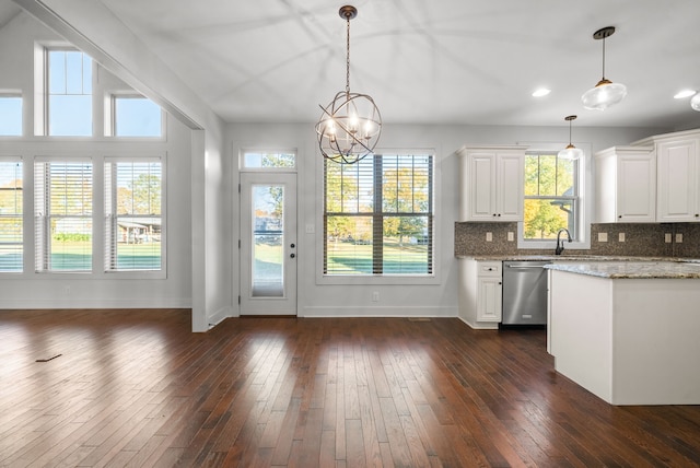 kitchen with white cabinetry, decorative light fixtures, stainless steel dishwasher, dark wood-type flooring, and light stone counters