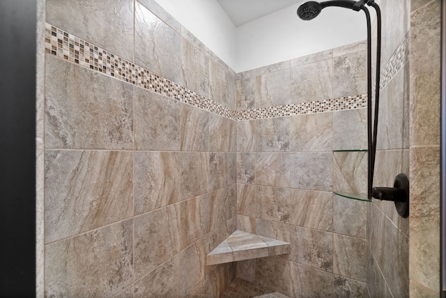 bathroom with a tile shower