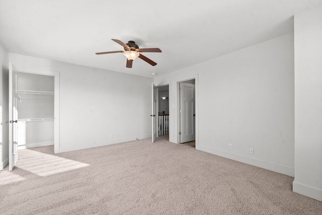 unfurnished bedroom with light carpet, a closet, and ceiling fan