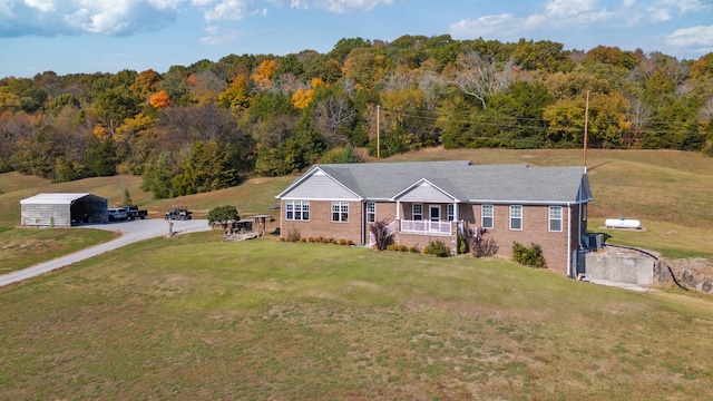 ranch-style house with a porch, a front lawn, and central AC