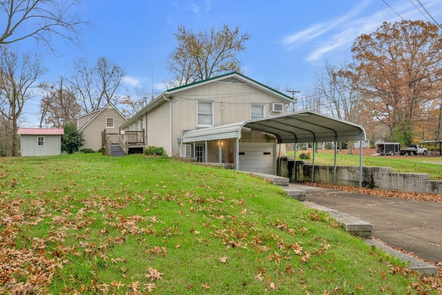 view of home's exterior featuring a yard, a deck, a carport, a garage, and an outbuilding