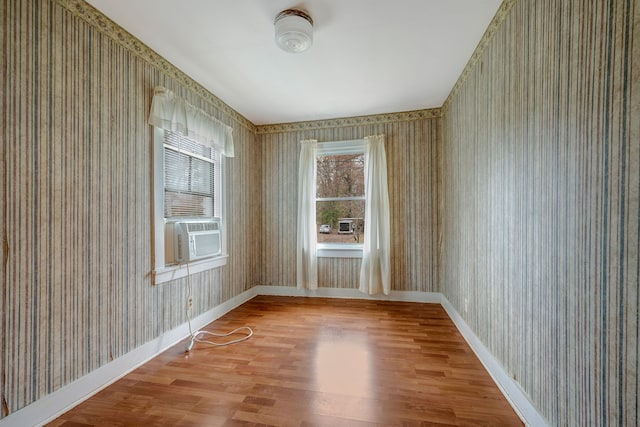 spare room with hardwood / wood-style flooring and cooling unit