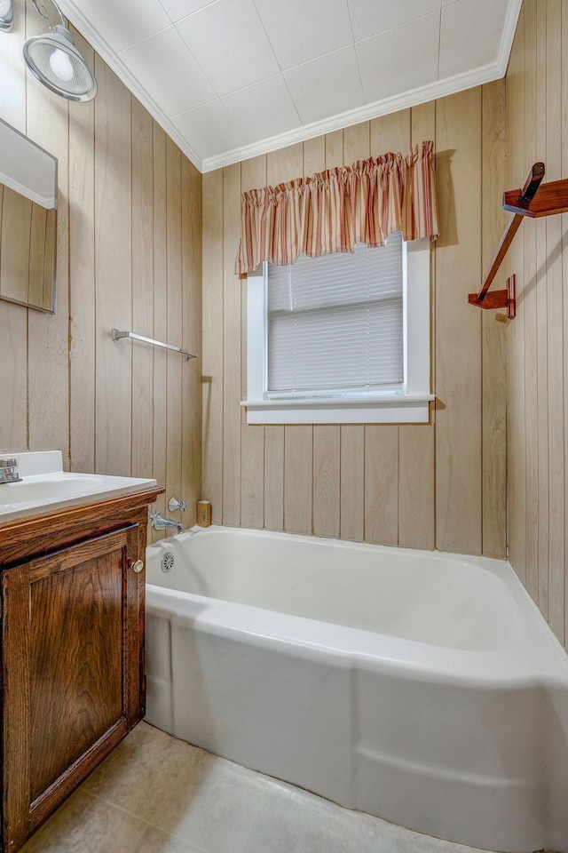 bathroom with a bath, tile patterned floors, wooden walls, vanity, and ornamental molding