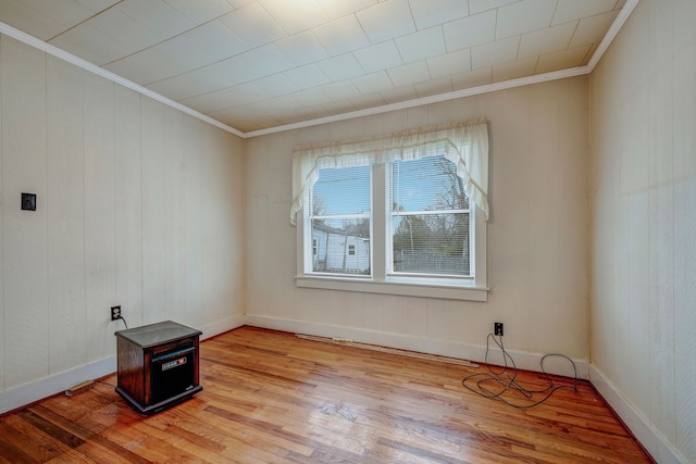 unfurnished room with light hardwood / wood-style floors and ornamental molding