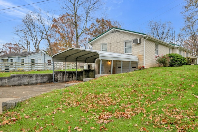 view of property exterior featuring a wall unit AC, a yard, and a carport