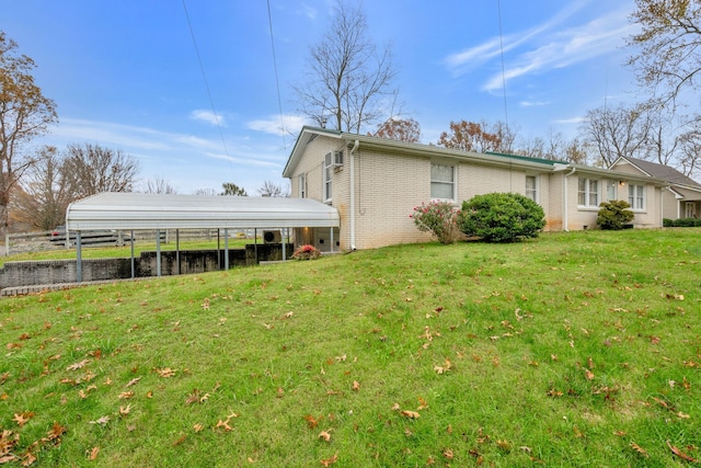 view of home's exterior with a lawn and a carport