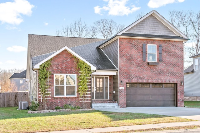 view of front of property featuring cooling unit, a garage, and a front yard