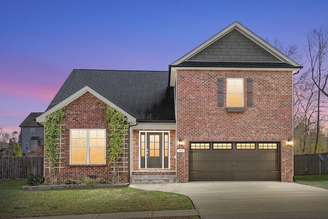 view of front property featuring a yard and a garage