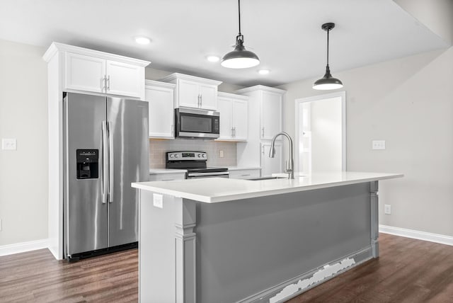 kitchen with sink, decorative light fixtures, dark hardwood / wood-style flooring, white cabinetry, and stainless steel appliances