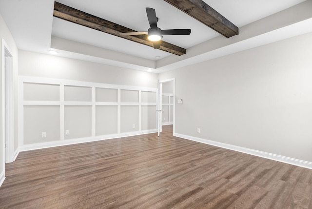 spare room featuring wood-type flooring, ceiling fan, and beam ceiling