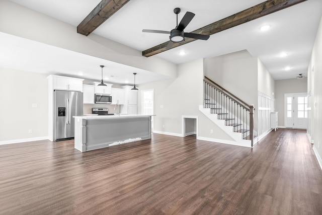 unfurnished living room with dark hardwood / wood-style floors, beam ceiling, and ceiling fan