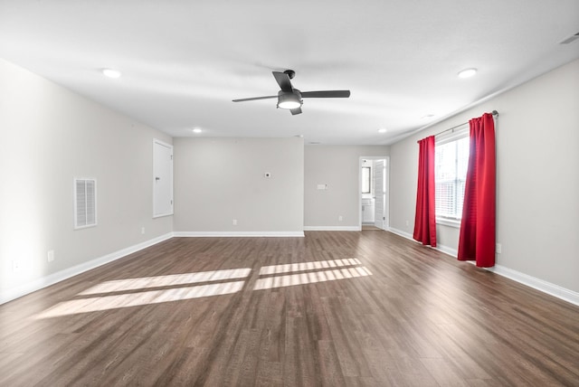 empty room with ceiling fan and dark wood-type flooring