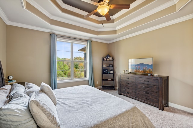 bedroom featuring light carpet, crown molding, a raised ceiling, and ceiling fan