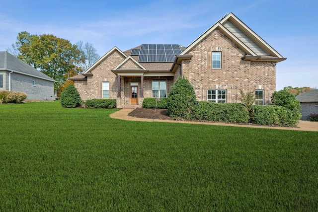 craftsman-style house featuring solar panels and a front yard