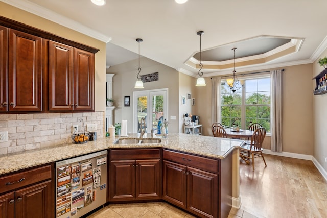 kitchen with kitchen peninsula, decorative backsplash, light stone countertops, stainless steel dishwasher, and sink