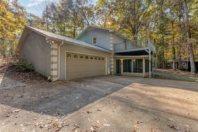 view of front facade with a balcony and a garage