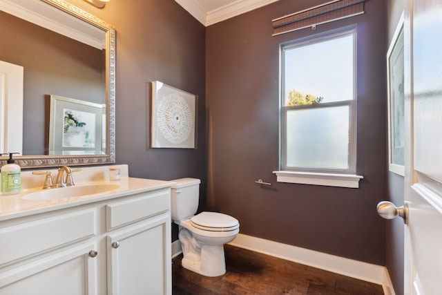 bathroom featuring toilet, ornamental molding, and vanity