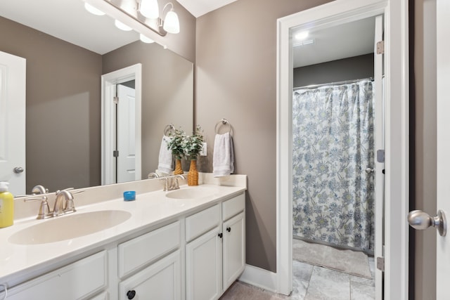 bathroom featuring vanity and curtained shower