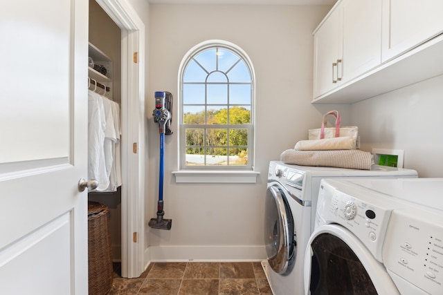 laundry room with cabinets and washing machine and clothes dryer