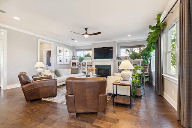 living room with ornamental molding, a healthy amount of sunlight, and dark hardwood / wood-style flooring