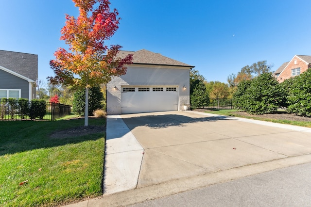 view of front of property with a front yard and a garage