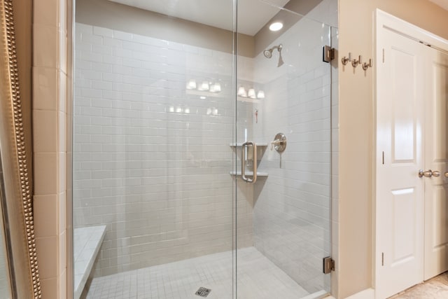 bathroom with a shower with door