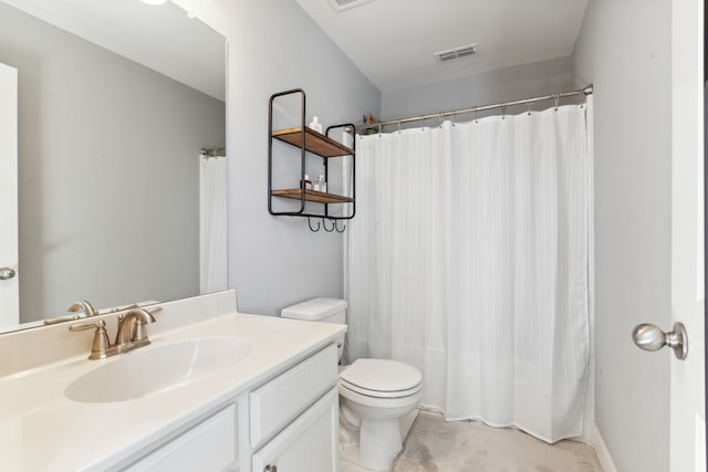 bathroom with vanity, toilet, and walk in shower