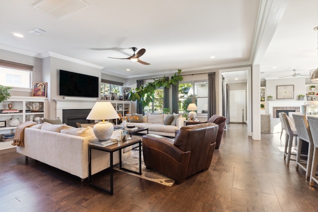 living room featuring dark hardwood / wood-style flooring, ornamental molding, ceiling fan, and a wealth of natural light